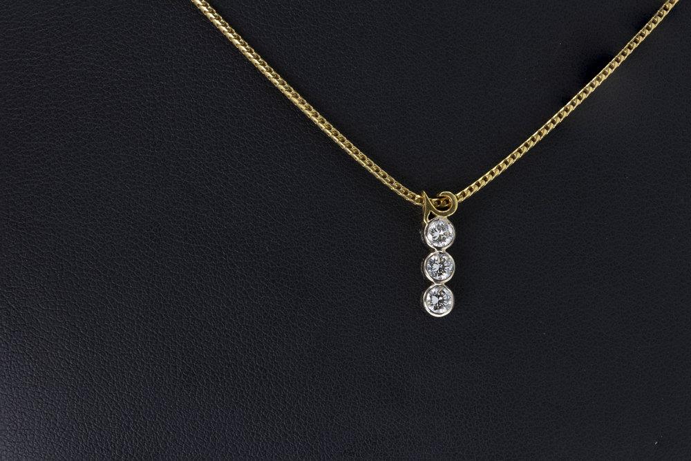 An 18ct gold and diamond '2000' necklace featuring approximately 0.35ct of brilliant cut diamonds held in bezel settings and used to.