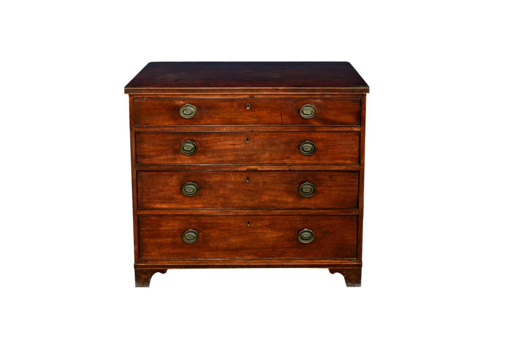 An early 19th century mahogany four drawer straight front chest the boxwood strung top over four graduated drawers with oval brass h...