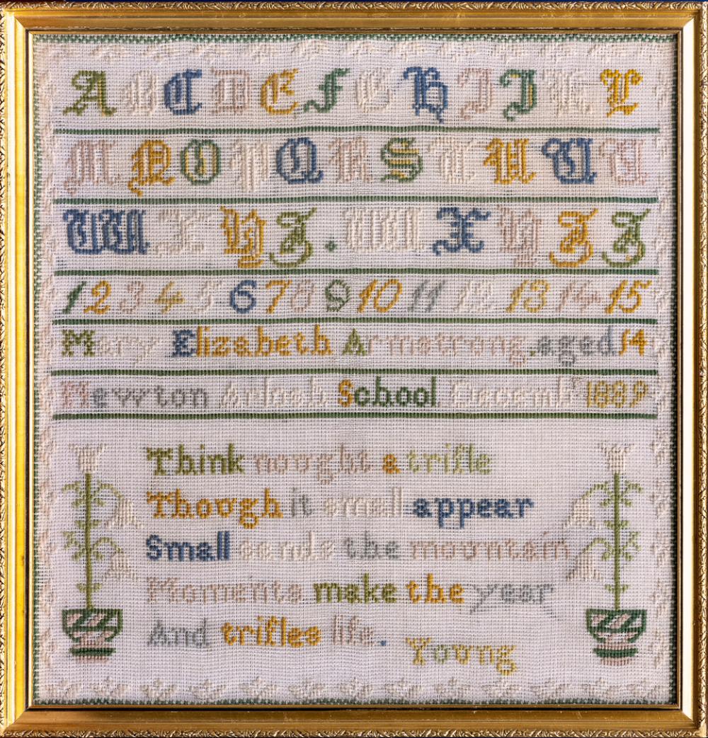 A Victorian needlework sampler Mary Elizabeth Armstrong aged 14, 1889, worked in coloured wools with alphabet and verse,