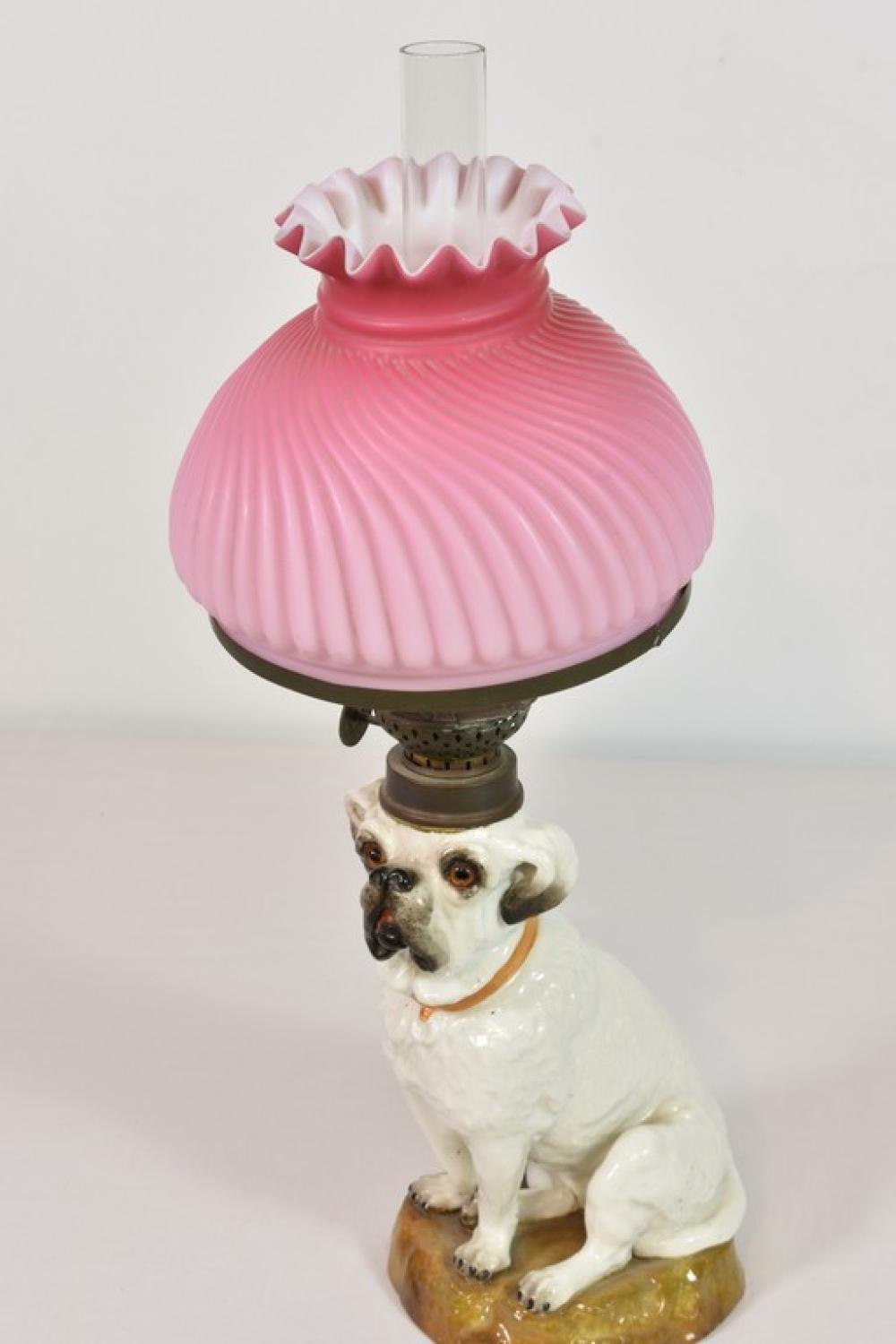 A Staffordshire pottery Bull Terrier dog converted to oil lamp pink milk glass shade (restored), dog, with tiny chip to base,