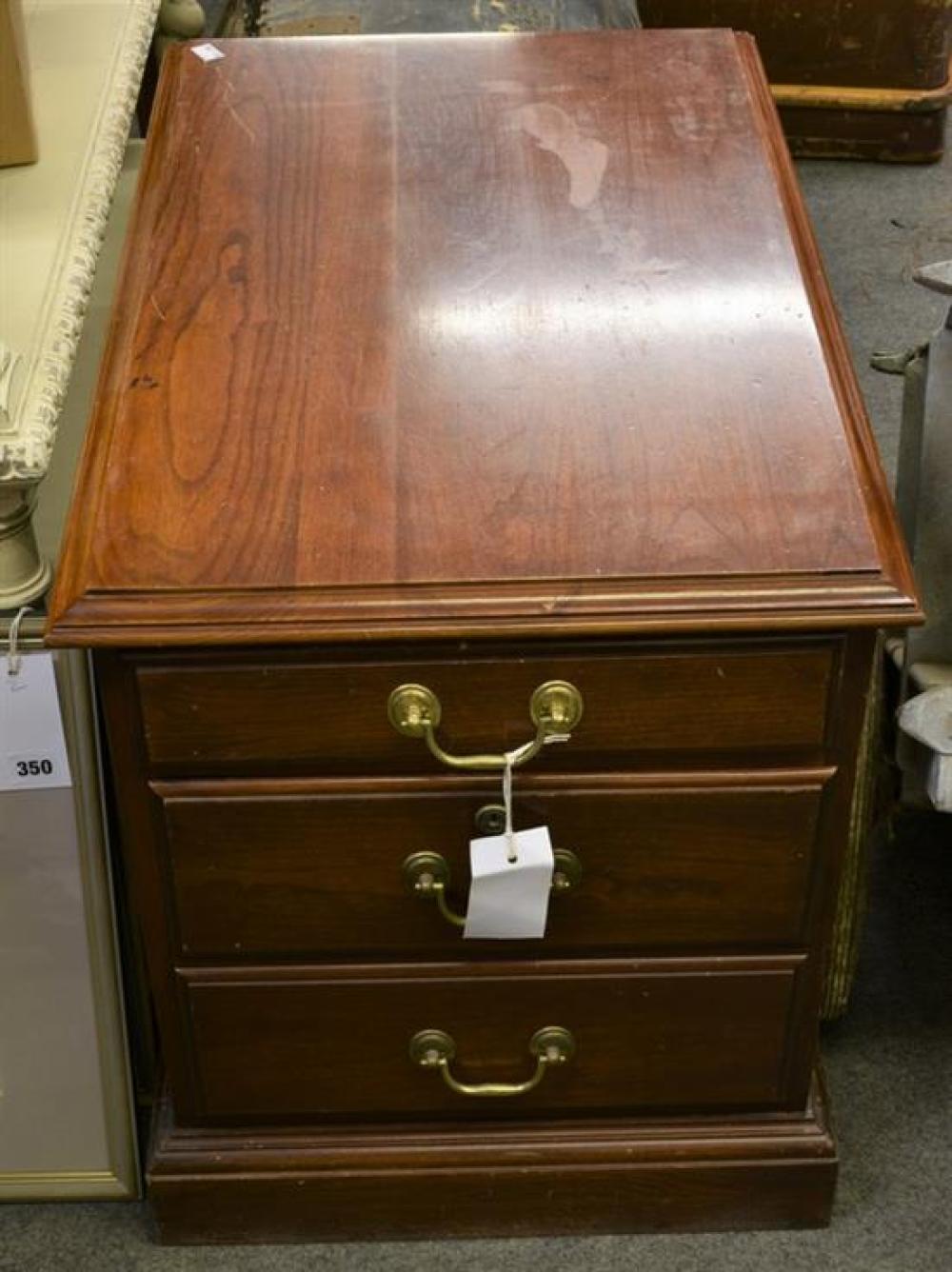 A small mahogany two drawer filing cabinet.