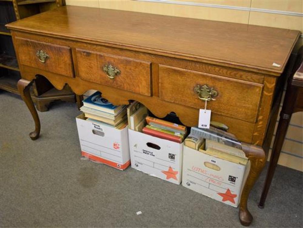 A Georgian style dresser base with three frieze drawers over a shaped apron, on cabriole fore legs.