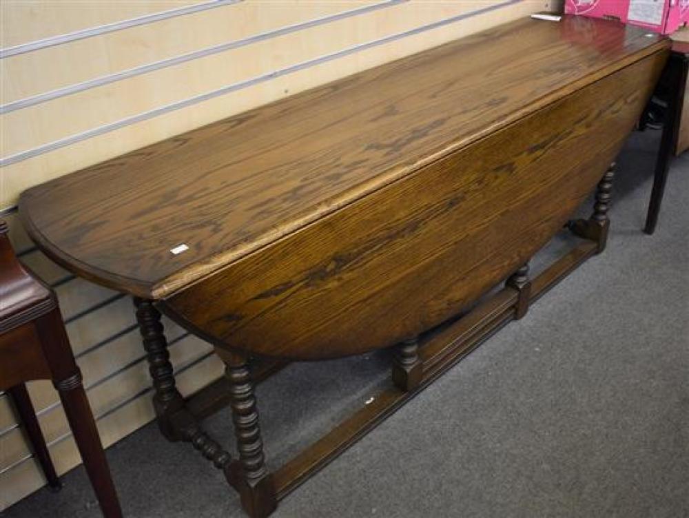 A reproduction oak gate leg dining table, oval top with two drawers on square stretcher, 196cm x 143cm