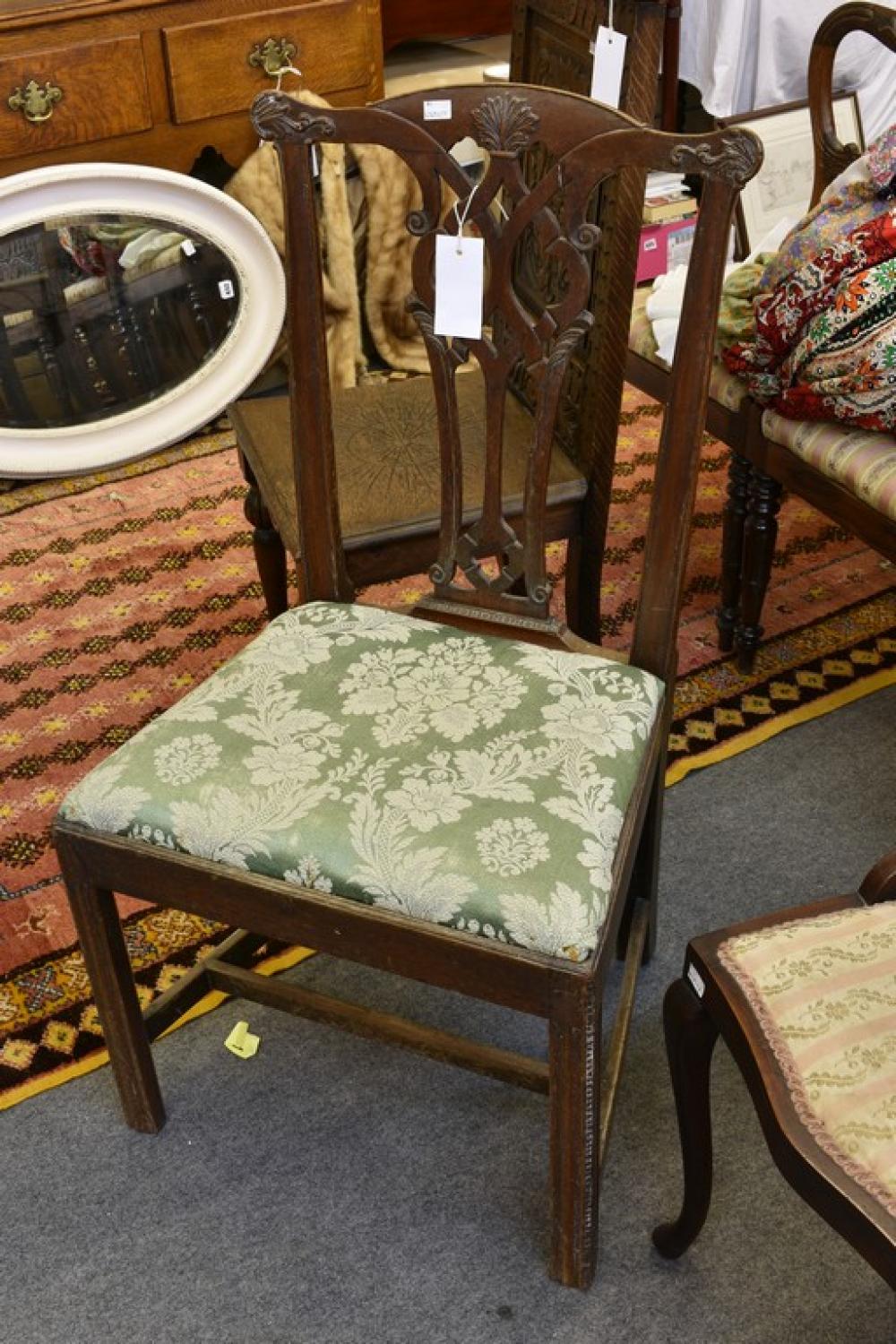 A Chippendale style dining chair, 3rd quarter 18th century, foliate carved yoke back over an interlaced,