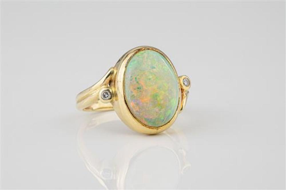 A 14ct yellow gold, opal and diamond ring the 13 x 10mm. oval cabochon opal over pierced,