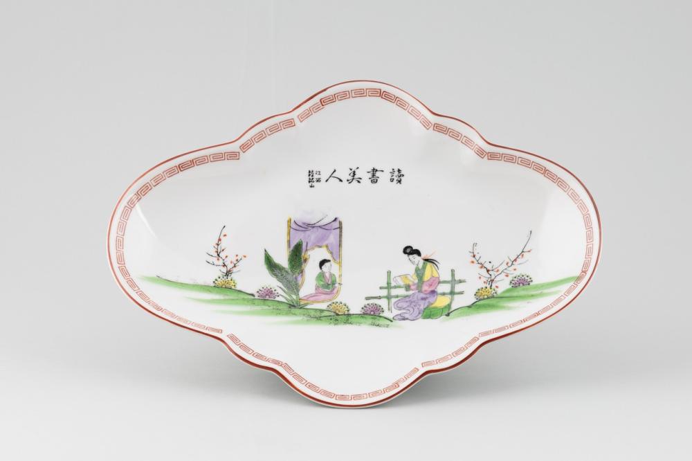 A Chinese famille rose lozenge shaped porcelain dish on footed base, 14 x 10 1/4 in. (35.6 x 26 cm.)