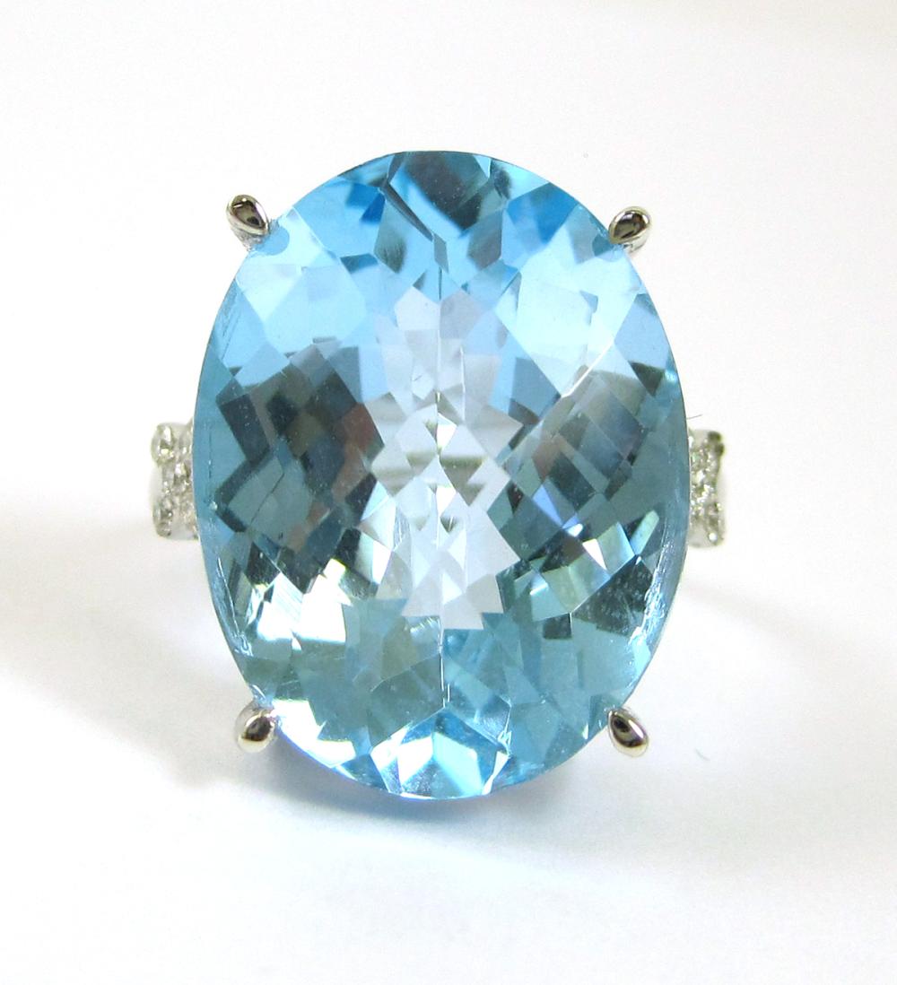 BLUE TOPAZ, DIAMOND AND FOURTEEN KARAT GOLD RING.