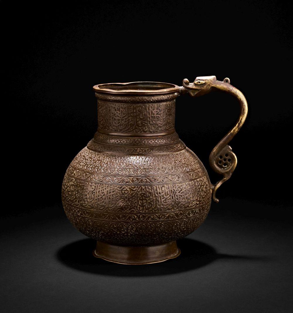 A ENGRAVED TINNED COPPER JUG WITH DRAGON HANDLE, 17TH/18TH CENTURY, DECCAN OR PERSIA