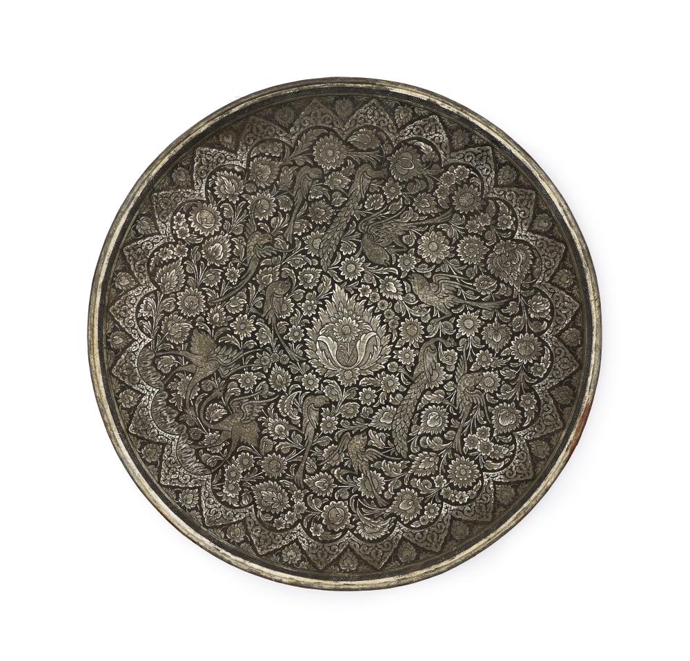 A LARGE WHITE METAL ENGRAVED FLORAL & PEACOCK DISH, INDIA, PROBABLY MUGHAL, 19TH CENTURY AND LATER