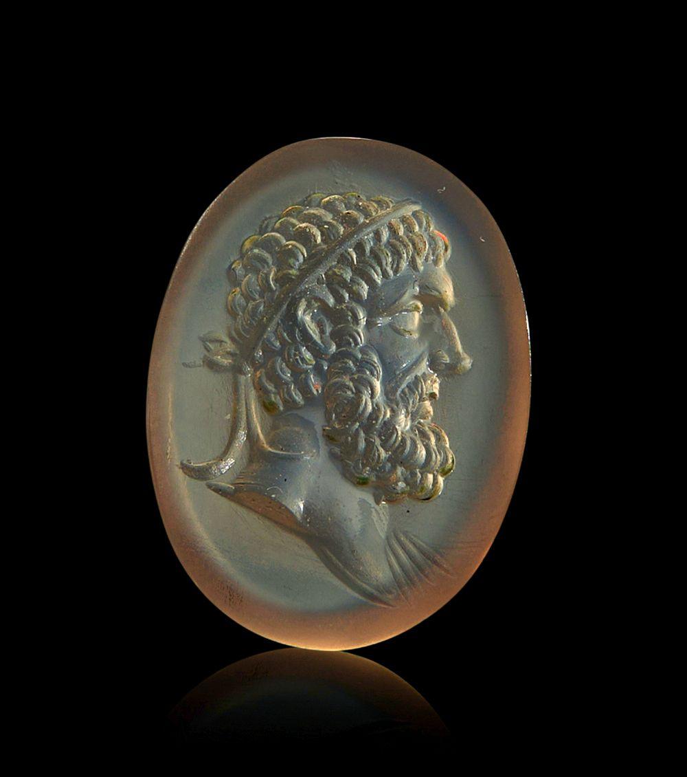 A ROMAN INTAGLIO WITH HEAD OF HERCULES CIRCA 2ND-3RD CENTURY A.D.