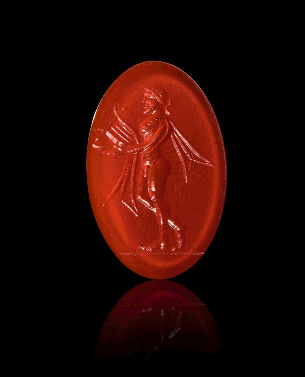 A ROMAN CARNELIAN INTAGLIO OF A STANDING MAN PLAYING THE LYRE, CIRCA 2ND CENTURY A.D.