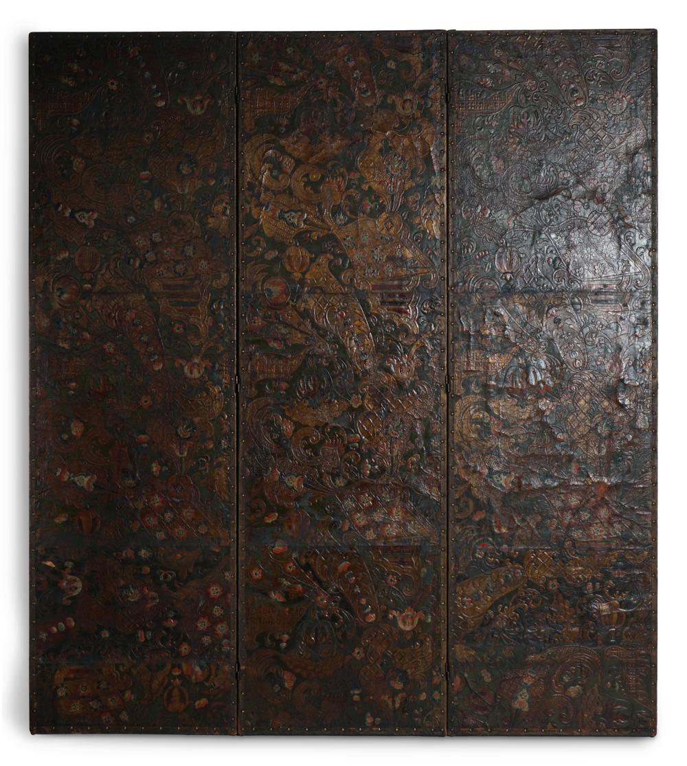 CONTINENTAL BAROQUE STYLE GOLD AND POLYCHROME PAINTED EMBOSSED LEATHER THREE PANEL SCREEN, EARLY 20TH CENTURY 23 x 78 1/2 in. (58.4 x 199.4 cm.)