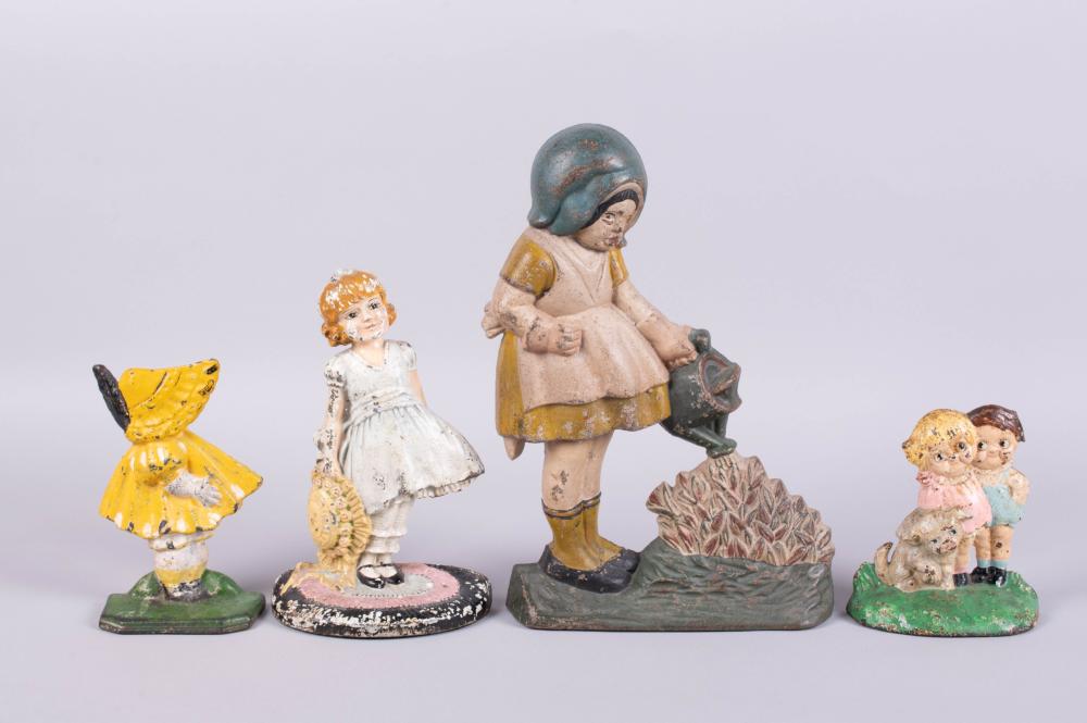 GROUP OF CAST IRON DOORSTOPS IN THE FORM OF CHILDREN