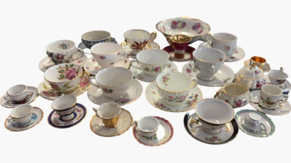 Assorted Collection of Porcelain Cups, Saucers, and Creamers with Floral and Gilded Designs
