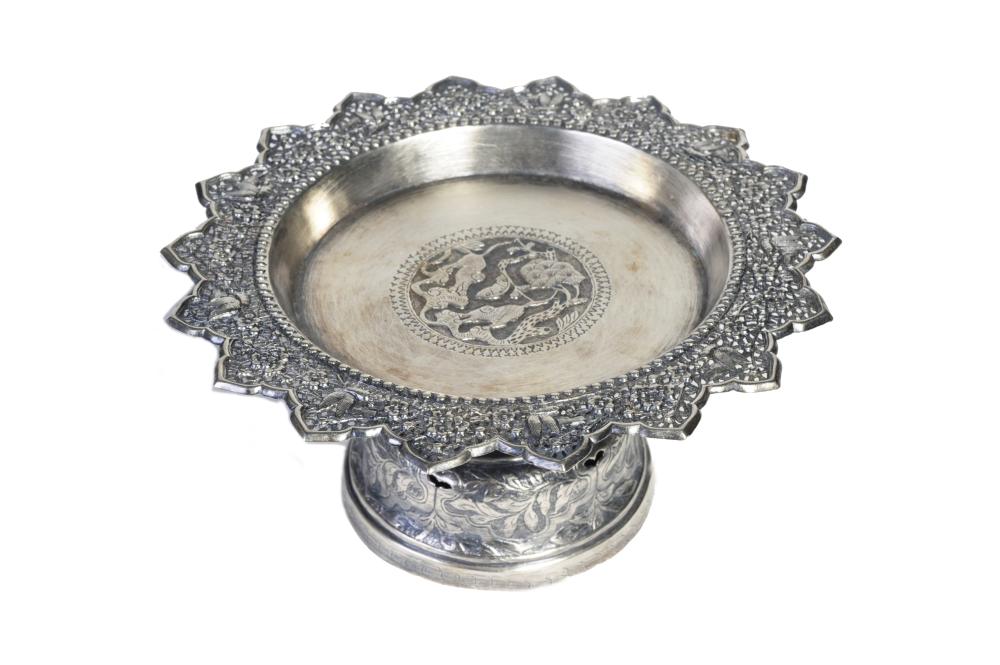 A carved and repousse' silver stem tray decorated with birds in flight among flowers and plum branches