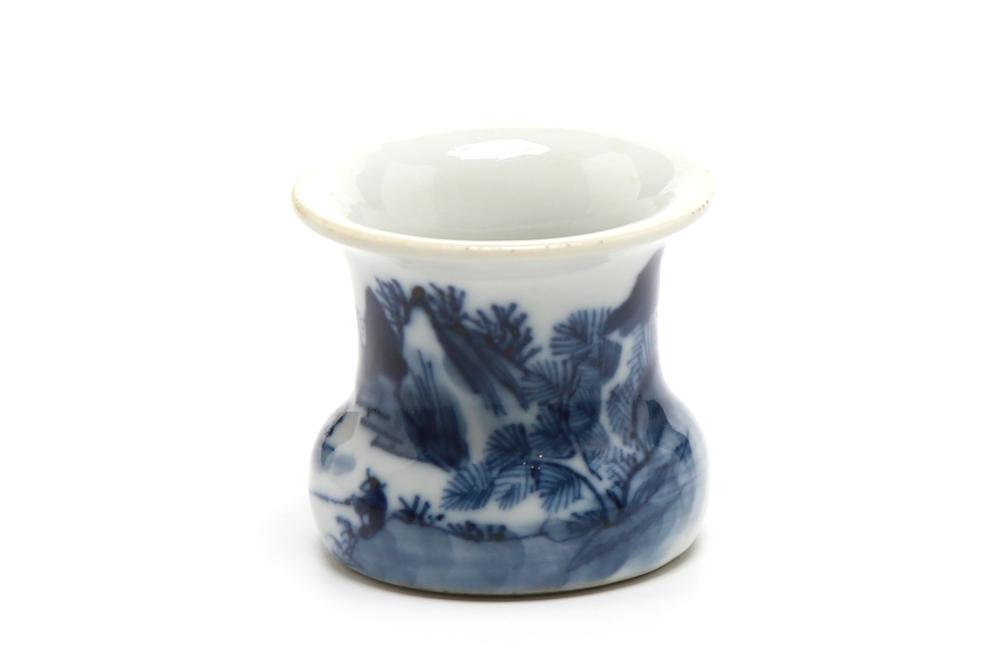 A small blue and white porcelain vase painted with landscape pattern