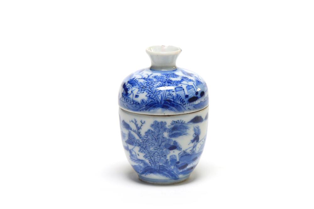 A blue and white porcelain covered teacup painted with a continuous of landscape design