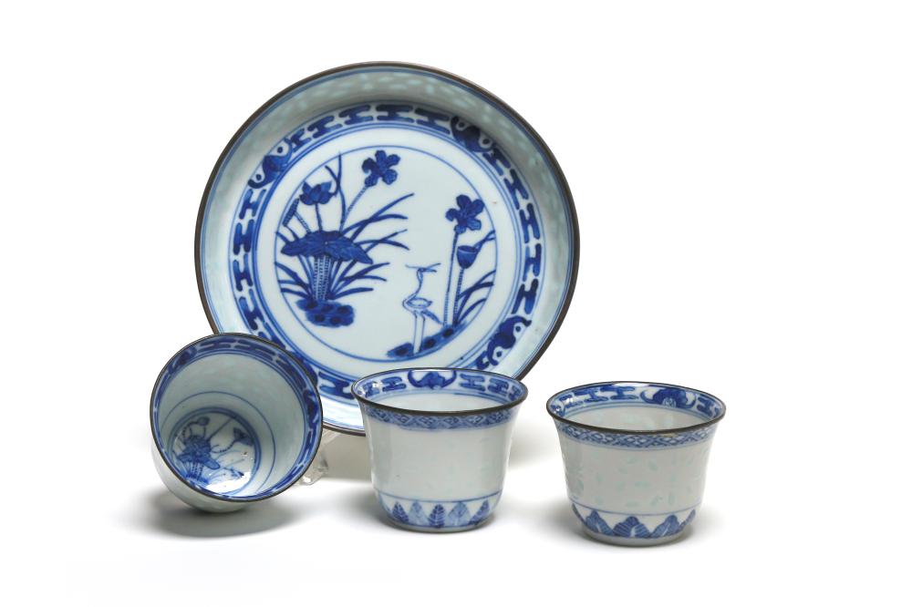 A blue and white porcelain tea set painted with flower blossom on a background