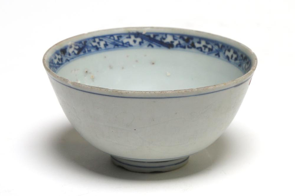 A blue and white porcelain Ming bowl painted with floral vine scrolls