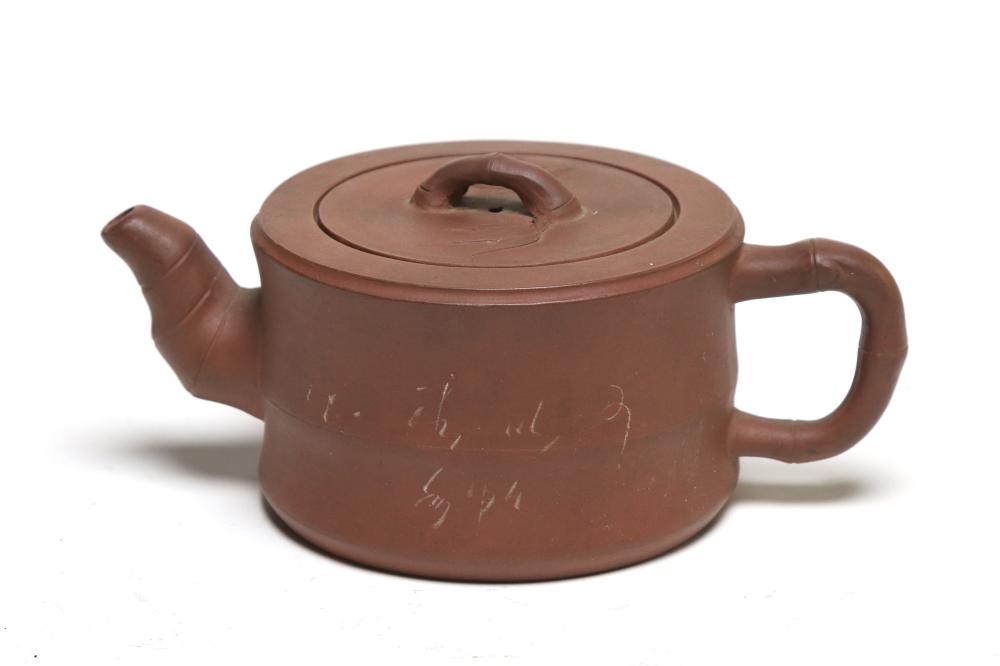 A pottery cylindrical teapot decorated with bamboo branch at handle