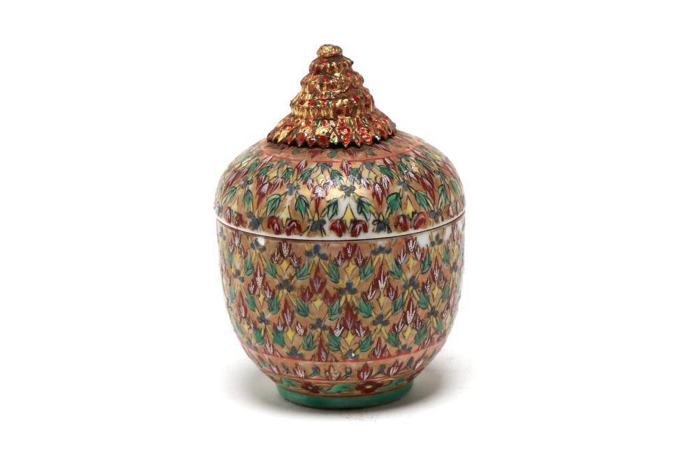 A Benjarong Lai Nam Thong covered jar with gold enameled finial on top painted with a geometric trellis and rice design on a gold ground