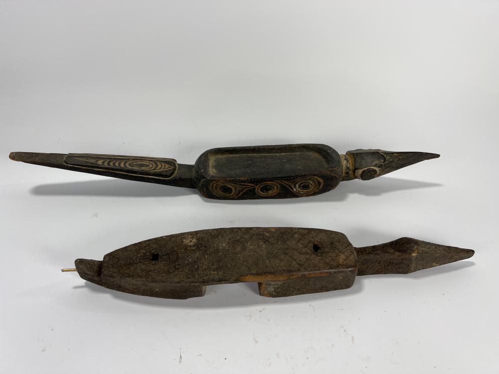2 Itombwa, which are friction oracle or divination instruments used by the Oceanic Kuba peoples of Zaire. Divining instruments., 25” x 4” x 2 1/4” (largest)