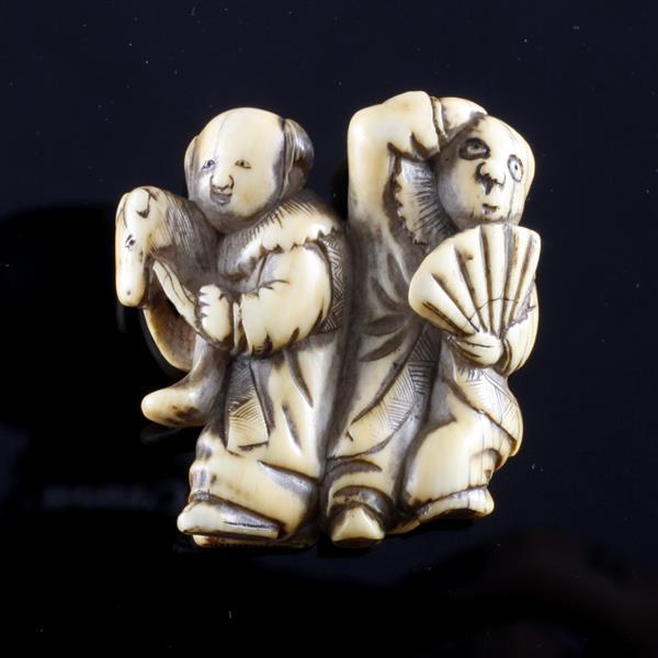 Japanese carved netsuke figure group of two theatrical characters with horse and fan.