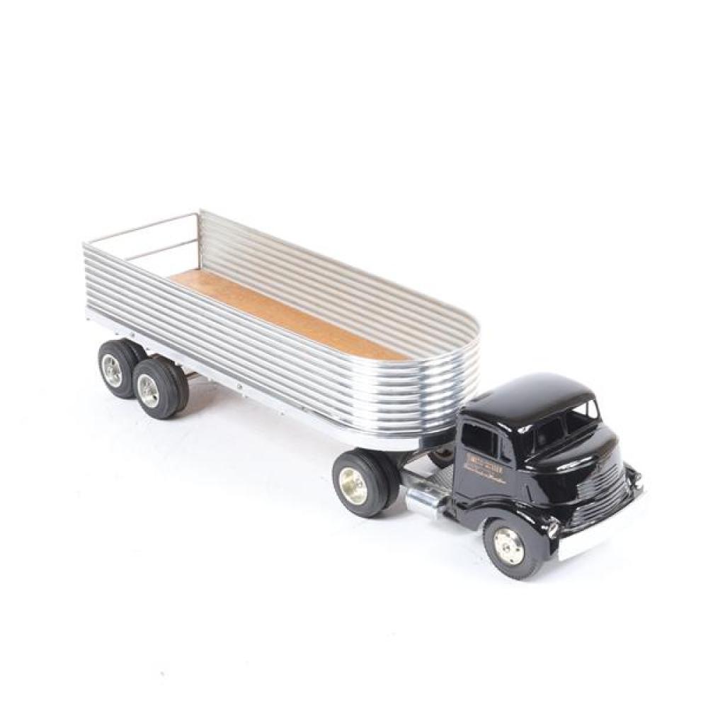 Smith Miller pressed steel toy black truck with rounded open metal trailer