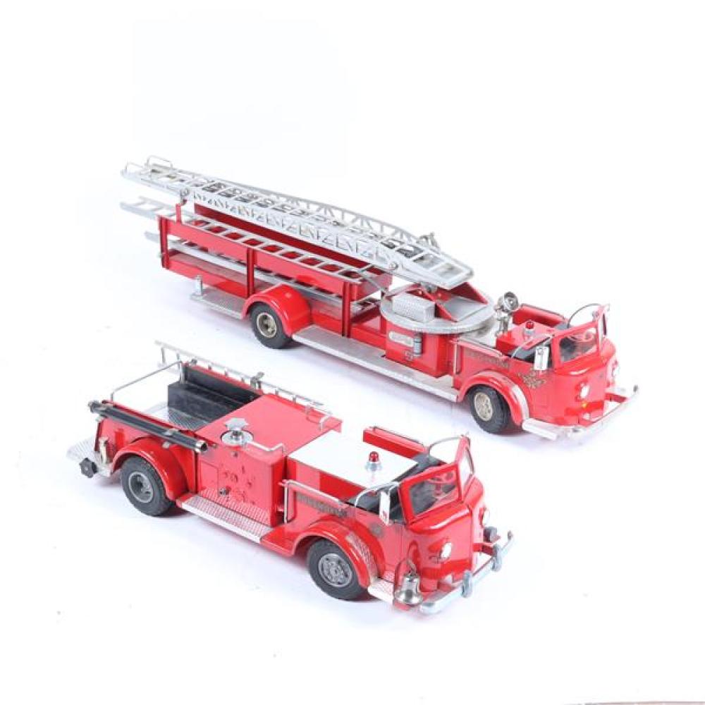 Two Model red pressed steel toy Rossmoyne firetrucks; large #5 with mechanical extension ladder, smaller with winding hose.