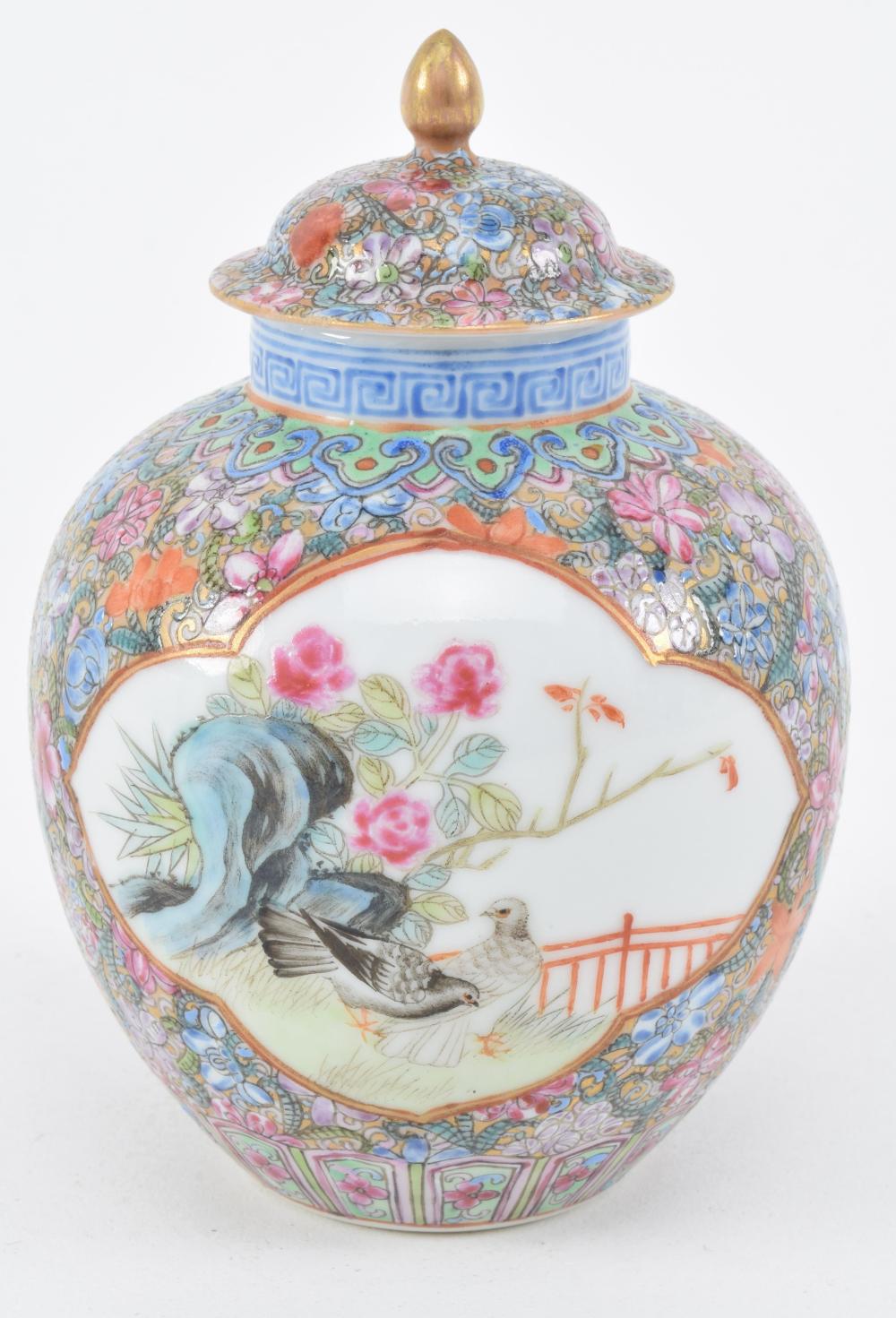 Porcelain covered jar. China. Early 20th century. Millefleur ground. Famille rose reserves of birds and flowers. Chien Lung mark. 4.5in high.